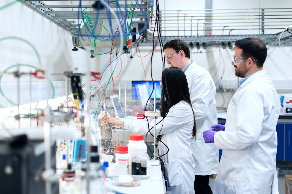 Pharmaceutical laboratory with specialists in white coats — work in a regulated industry environment